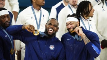 Aug 10, 2024; Paris, France; United States guard LeBron James (6) and centre Anthony Davis (14) celebrate with their gold medals on the podium after defeating France in the men's basketball gold medal game during the Paris 2024 Olympic Summer Games at Accor Arena. Mandatory Credit: Rob Schumacher-USA TODAY Sports