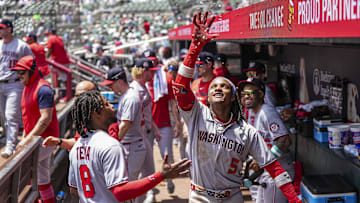 May 15, 2025; Cumberland, Georgia, USA; Washington Nationals shortstop CJ Abrams (5) has seeds tossed at him by third base Jose Tena (8) after hitting a home run against the Atlanta Braves during the eighth inning at Truist Park