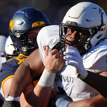 Nov 18, 2023; Morgantown, West Virginia, USA; Cincinnati Bearcats defensive lineman Dontay Corleone (2) is double-teamed on a pass rush against the West Virginia Mountaineers in the first quarter at Milan Puskar Stadium.  Mandatory Credit: Kareem Elgazzar-Imagn Images