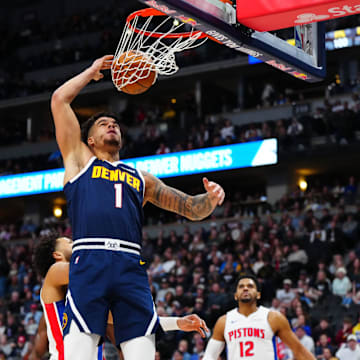 Dec 28, 2024; Denver, Colorado, USA; Denver Nuggets forward Michael Porter Jr. (1) finishes off a basket in the first quarter against the Detroit Pistons at Ball Arena. Mandatory Credit: Ron Chenoy-Imagn Images
