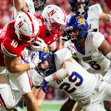 Sep 14, 2024; Lincoln, Nebraska, USA; Nebraska Cornhuskers quarterback Heinrich Haarberg (10) runs against Northern Iowa Panthers linebacker Tucker Langenberg (29) during the third quarter at Memorial Stadium.