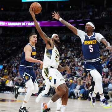 Jan 14, 2024; Denver, Colorado, USA; Denver Nuggets guard Kentavious Caldwell-Pope (5) defends on Indiana Pacers forward Isaiah Jackson (22) in the second half at Ball Arena. Mandatory Credit: Ron Chenoy-USA TODAY Sports