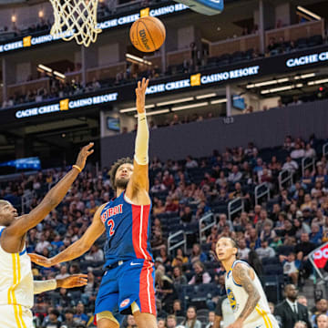 Oct 13, 2024; San Francisco, California, USA;  Detroit Pistons guard Cade Cunningham (2) shoot the layup against Golden State Warriors forward Jonathan Kuminga (00) during the second quarter at Chase Center. Mandatory Credit: Neville E. Guard-Imagn Images