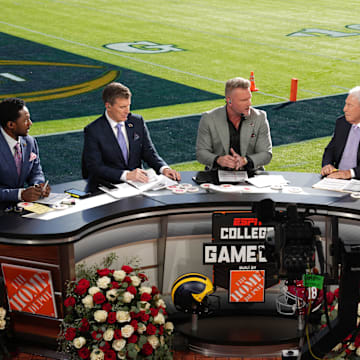 Jan 1, 2024; Pasadena, CA, USA; From left: Desmond Howard, Rece Davis, Pat McAfee, Lee Corso and Kirk Herbstreit on the ESPN College Gameday set at the 2024 Rose Bowl college football playoff semifinal game at Rose Bowl. Mandatory Credit: Kirby Lee-Imagn Images