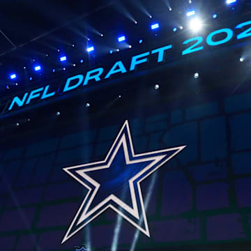 The Dallas Cowboys logo is projected on the video board during the NFL Draft at Lambeau Field. 