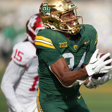 Nov 29, 2025; Waco, Texas, USA;  Baylor Bears wide receiver Josh Cameron (34) makes a touchdown catch against Houston Cougars defensive back Will James (15) during the second half at McLane Stadium. Mandatory Credit: Chris Jones-Imagn Images