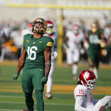 Baylor Bears wide receiver Kobe Prentice (16) reacts after making a catch against Houston Cougars defensive back Will James (15) during the second half at McLane Stadium