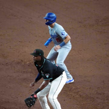 Sep 1, 2024; Phoenix, Arizona, USA; Los Angeles Dodgers catcher Austin Barnes (15) leads off first as Arizona Diamondbacks first base Josh Bell (36) covers the bag during the sixth inning at Chase Field. Mandatory Credit: Joe Camporeale-USA TODAY Sports