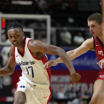 Jul 12, 2024; Las Vegas, NV, USA;  Washington Wizards guard Bub Carrington (17) drives the ball against Atlanta Hawks guard Nikola Durisic (7) during the second half at Thomas & Mack Center. Mandatory Credit: Lucas Peltier-Imagn Images