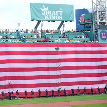 Apr 15, 2024; Boston, Massachusetts, USA; A general view of the American flag draped over the Green Monster during the national anthem prior to the game between the Cleveland Guardians and Boston Red Sox at Fenway Park. Mandatory Credit: Gregory Fisher-Imagn Images