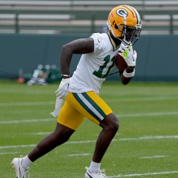 Green Bay Packers wide receiver Jayden Reed does a ball-security drill during minicamp. 