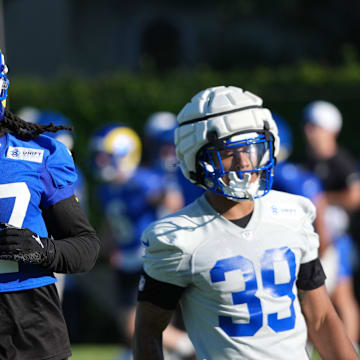 Jul 23, 2025; Los Angeles, CA, USA; Los Angeles Rams receiver Davante Adams (17) carries the ball against safety Malik Dixon-Williams (39) during training camp at Loyola Marymount University. Mandatory Credit: Kirby Lee-Imagn Images