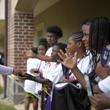 Jul 27, 2023; Owings Mills, MD, USA; Baltimore Ravens quarterback Lamar Jackson (8) greets fans after training camp practice at Under Armour Performance Center. Mandatory Credit: Brent Skeen-USA TODAY Sports