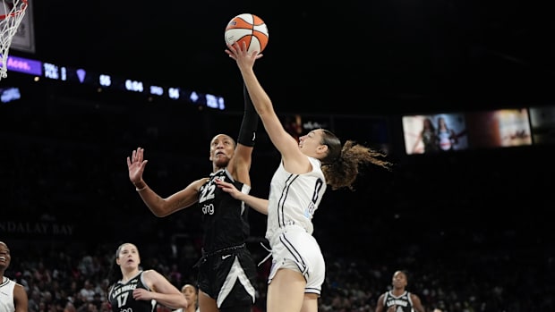 Golden State Valkyries guard Carla Leite attempts to score a layup against Las Vegas Aces center A'ja Wilson.