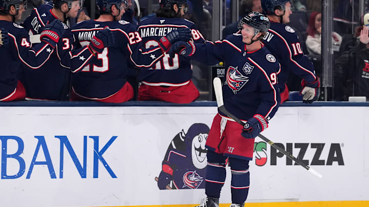 Blue Jackets forward Kent Johnson celebrates a goal with the bench.