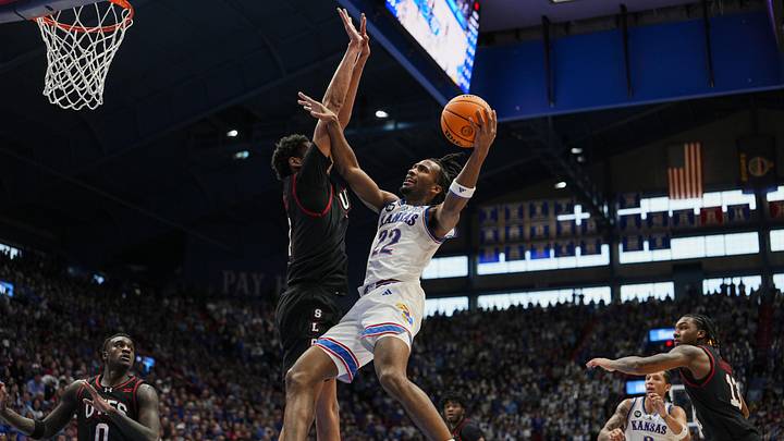 Feb 7, 2026; Lawrence, Kansas, USA; Kansas Jayhawks guard Darryn Peterson (22) shoots against Utah Utes forward Josh Hayes (7) during the second half at Allen Fieldhouse. Mandatory Credit: Jay Biggerstaff-Imagn Images