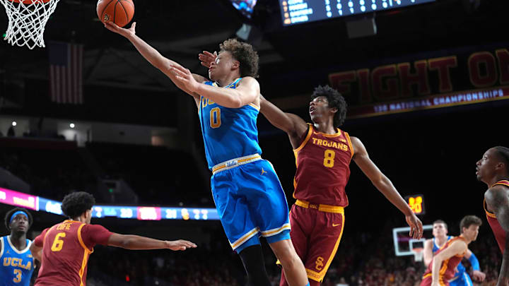 Mar 7, 2026; Los Angeles, California, USA; UCLA Bruins guard Trent Perry (0) shoots the ball against Southern California Trojans guard Jerry Easter II (8) in the first half at Galen Center. Mandatory Credit: Kirby Lee-Imagn Images