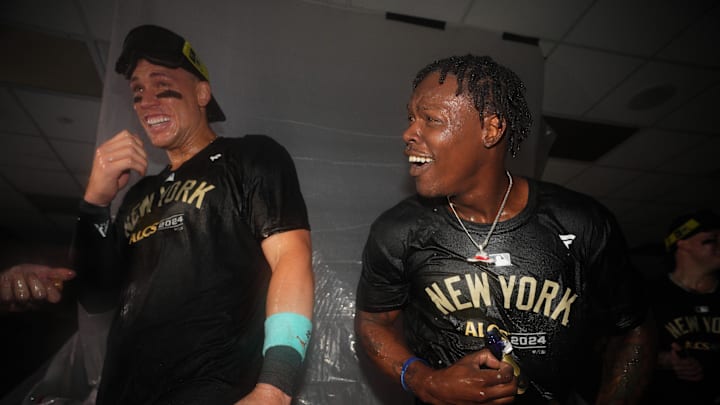 Oct 10, 2024; Kansas City, Missouri, USA; New York Yankees outfielder Aaron Judge (99) and third baseman Jazz Chisholm Jr. (13) spray champagne as the New York Yankees celebrate a win over the Kansas City Royals during game four of the ALDS for the 2024 MLB Playoffs at Kauffman Stadium. Mandatory Credit: Jay Biggerstaff-Imagn Images