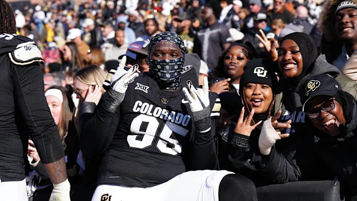 Nov 29, 2024; Boulder, Colorado, USA; Colorado Buffaloes defensive tackle Tawfiq Thomas (95) celebrates the win with fans following the game against the Oklahoma State Cowboys at Folsom Field. Mandatory Credit: Ron Chenoy-Imagn Images