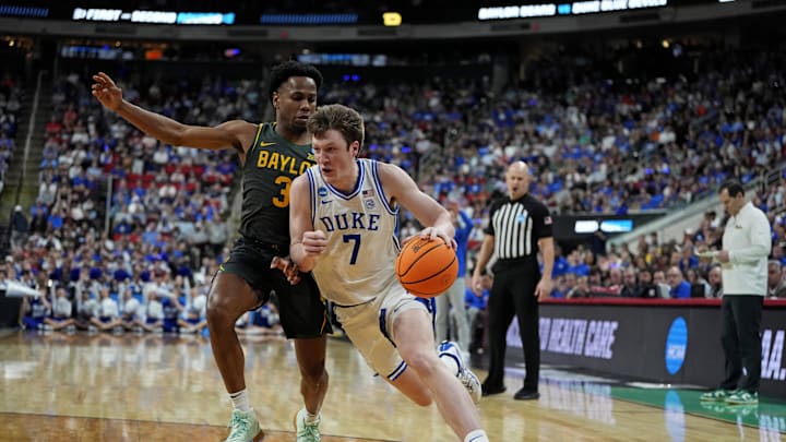 Mar 23, 2025; Raleigh, NC, USA; Duke Blue Devils guard Kon Knueppel (7) drives to the basket as Baylor Bears guard Jeremy Roach (3) defends during the first half in the second round of the NCAA Tournament at Lenovo Center. Mandatory Credit: Bob Donnan-Imagn Images
