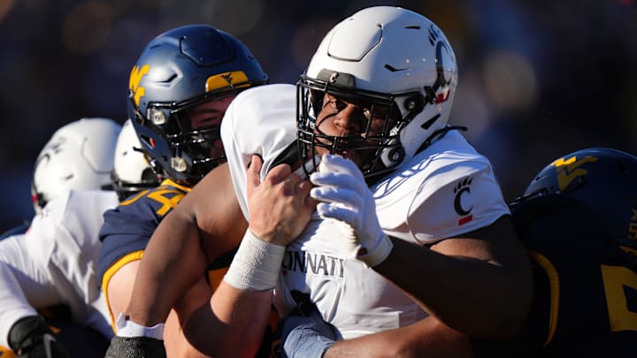 Nov 18, 2023; Morgantown, West Virginia, USA; Cincinnati Bearcats defensive lineman Dontay Corleone (2) is double-teamed on a pass rush against the West Virginia Mountaineers in the first quarter at Milan Puskar Stadium.  Mandatory Credit: Kareem Elgazzar-Imagn Images