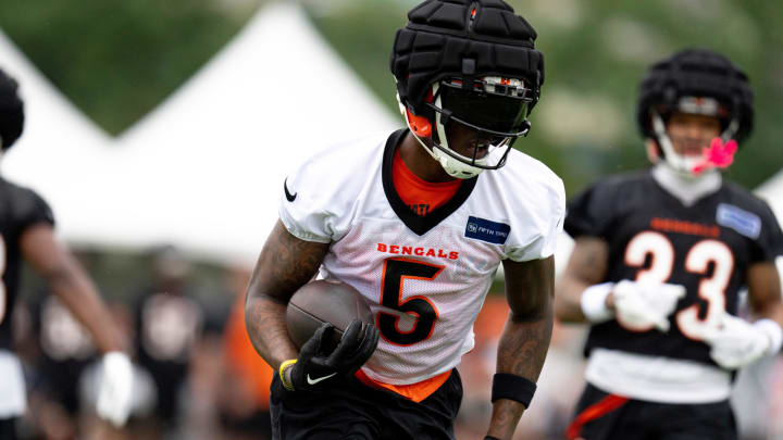 Cincinnati Bengals wide receiver Tee Higgins (5) runs with the ball at Cincinnati Bengals training camp on the Kettering Health Practice Fields in Cincinnati on Sunday, July 28, 2024.