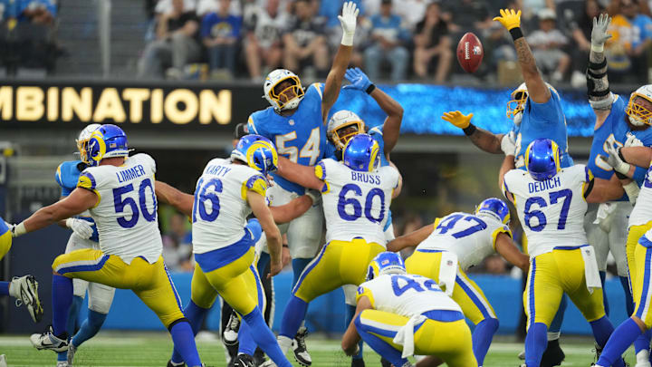 Aug 17, 2024; Inglewood, California, USA; Los Angeles Rams place kicker Joshua Karty (16) attempts a field goal against Los Angeles Chargers linebacker Savion Jackson (54) in the second half at SoFi Stadium. Mandatory Credit: Kirby Lee-Imagn Images