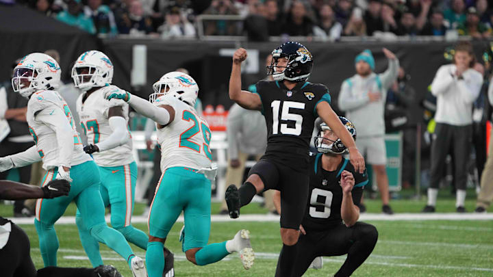 Jacksonville Jaguars kicker Matthew Wright (15) follows through on a 53-yard field goal out of the hold of punter Logan Cooke (9) as time expires against the Miami Dolphins  during an NFL International Series game at Tottenham Hotspur Stadium in 2021.