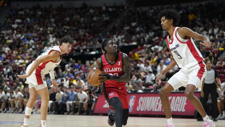 Jul 12, 2024; Las Vegas, NV, USA;  Atlanta Hawks guard Keaton Wallace (22) drives the ball against Washington Wizards forward John Butler Jr. (19) during the first half at Thomas & Mack Center. Mandatory Credit: Lucas Peltier-USA TODAY Sports