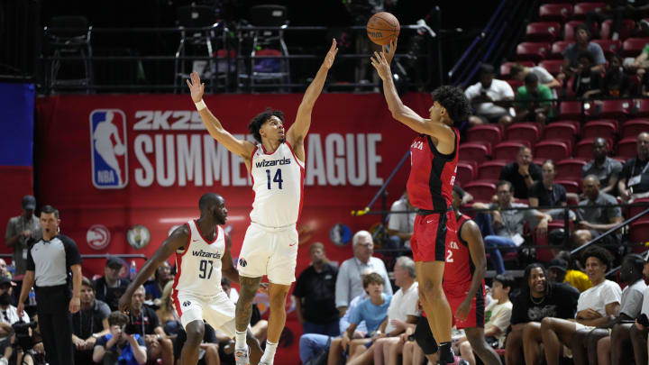 Jul 12, 2024; Las Vegas, NV, USA;  Washington Wizards guard Jules Bernard (14) attempts to block a shot by Atlanta Hawks forward Zaccharie Risacher (10) during the second half at Thomas & Mack Center. Mandatory Credit: Lucas Peltier-USA TODAY Sports