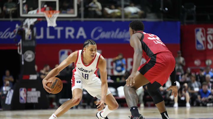 Jul 12, 2024; Las Vegas, NV, USA;  Washington Wizards forward Kyshawn George (18) controls the ball against Atlanta Hawks forward E.J. Liddell (32) during the second half at Thomas & Mack Center. Mandatory Credit: Lucas Peltier-Imagn Images