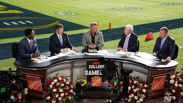 Jan 1, 2024; Pasadena, CA, USA; From left: Desmond Howard, Rece Davis, Pat McAfee, Lee Corso and Kirk Herbstreit on the ESPN College Gameday set at the 2024 Rose Bowl college football playoff semifinal game at Rose Bowl. Mandatory Credit: Kirby Lee-Imagn Images