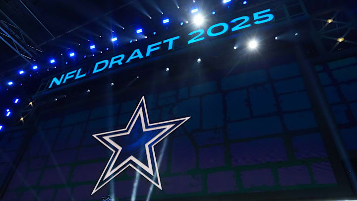 The Dallas Cowboys logo is projected on the video board during the NFL Draft at Lambeau Field. 