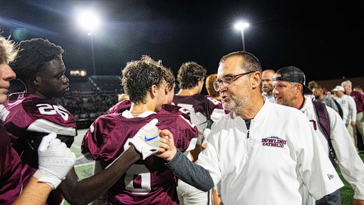 Dowling Catholic head coach Tom Wilson congratulates his players after an overtime win over WDM on Friday, Sept. 6, 2024, at Valley Stadium. Dowling Catholic head coach Tom Wilson congratulates his players after an overtime win over WDM on Friday, Sept. 6, 2024, at Valley Stadium.