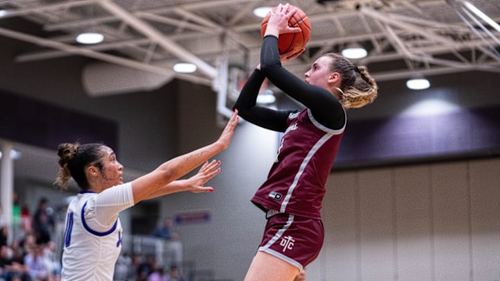 Dowling’s Katie Muller (11) shoots the ball over Johnston's Jenica Lewis (10) on Dec. 16, 2025, at Johnston High School.