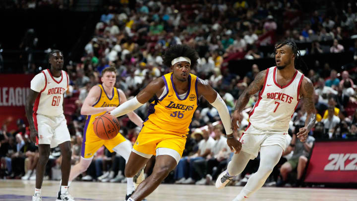 Jul 12, 2024; Las Vegas, NV, USA; Los Angeles Lakers forward Blake Hinson (36) drives the ball against Houston Rockets forward Cam Whitmore (7) during the second half at Thomas & Mack Center. Mandatory Credit: Lucas Peltier-USA TODAY Sports