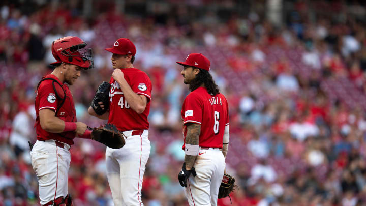 Cincinnati Reds catcher Tyler Stephenson (37) and Cincinnati Reds second baseman Jonathan India (6) conference with Cincinnati Reds starting pitcher Nick Lodolo (40) with the bases loaded in the third inning of the MLB game between the Cincinnati Reds and Kansas City Royals at Great American Ball Park in Cincinnati on Saturday, Aug. 17, 2024.