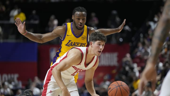 Jul 12, 2024; Las Vegas, NV, USA;  Houston Rockets guard Reed Sheppard (15) drives the ball against Los Angeles Lakers guard Bronny James (9) during the first half at the Thomas & Mack Center. Mandatory Credit: Lucas Peltier-USA TODAY Sports