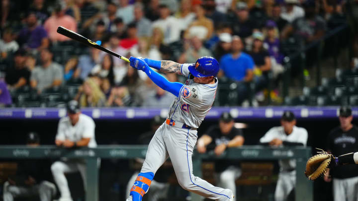 Aug 7, 2024; Denver, Colorado, USA; New York Mets outfielder Ben Gamel (21) singles in the seventh inning against the Colorado Rockies at Coors Field. Mandatory Credit: Ron Chenoy-USA TODAY Sports