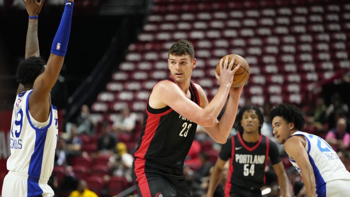 Jul 15, 2024; Las Vegas, NV, USA; Portland Trail Blazers center Donovan Clingan (23) controls the ball against the Philadelphia 76ers  during the first half at Thomas & Mack Center. Mandatory Credit: Lucas Peltier-USA TODAY Sports