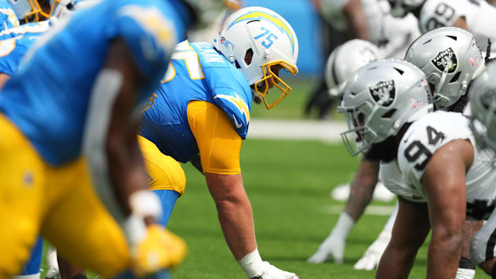 Sep 8, 2024; Inglewood, California, USA; Helmets at the line of scrimmage as Los Angeles Chargers center Bradley Bozeman (75) snaps the ball against the Las Vegas Raiders in the first half at SoFi Stadium. Mandatory Credit: Kirby Lee-Imagn Images