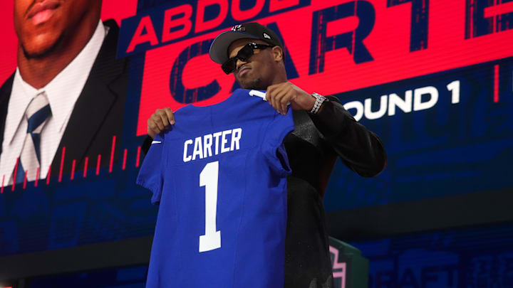 Abdul Carter holding up a Giants jersey after being drafted No. 3. Abdul Carter holding up a Giants jersey after being drafted No. 3.