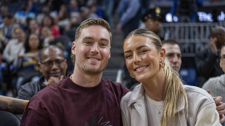 San Francisco 49ers running back Christian McCaffery and Olivia Culpo at a Warriors-76ers game in January 2024.
