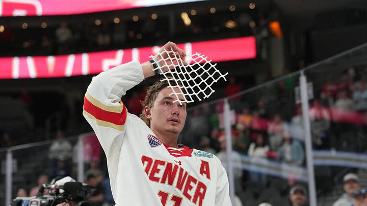Apr 11, 2026; Las Vegas, Nevada, United States; Denver Pioneers forward Samu Salminen (11) skates with parts of a cut net after defeating the Wisconsin Badgers in the championship game of the NCAA men's ice hockey Frozen Four at T-Mobile Arena. Mandatory Credit: Lucas Peltier-Imagn Images