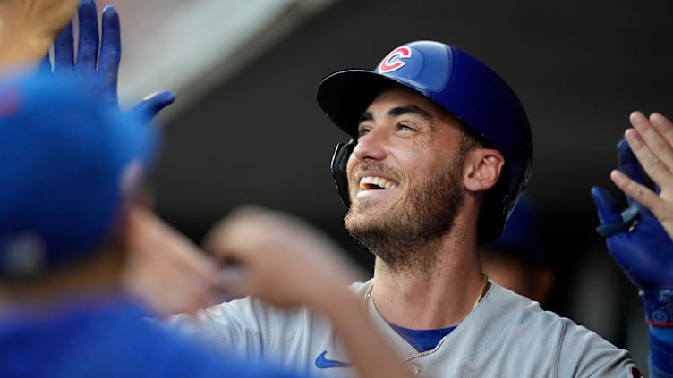 Chicago Cubs center fielder Cody Bellinger (24) celebrates in the dugout after hitting a solo home