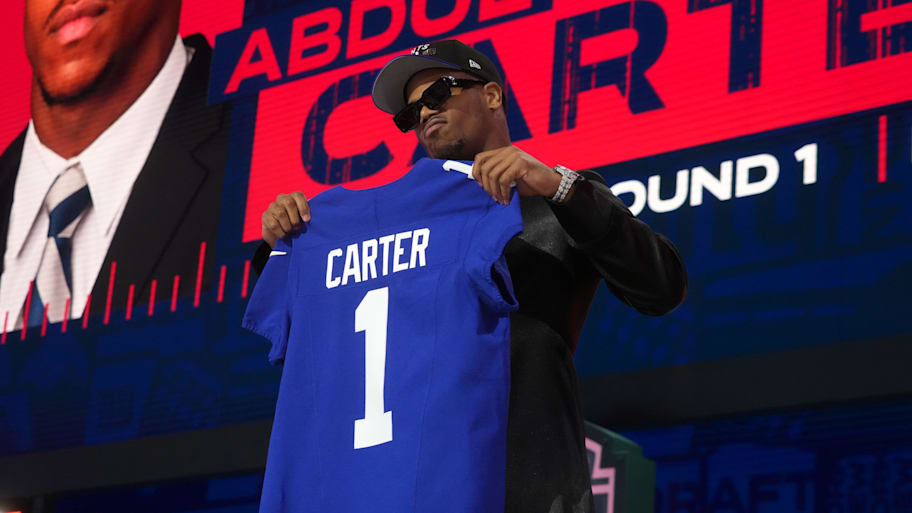 Abdul Carter holding up a Giants jersey after being drafted No. 3. | Kirby Lee-Imagn Images