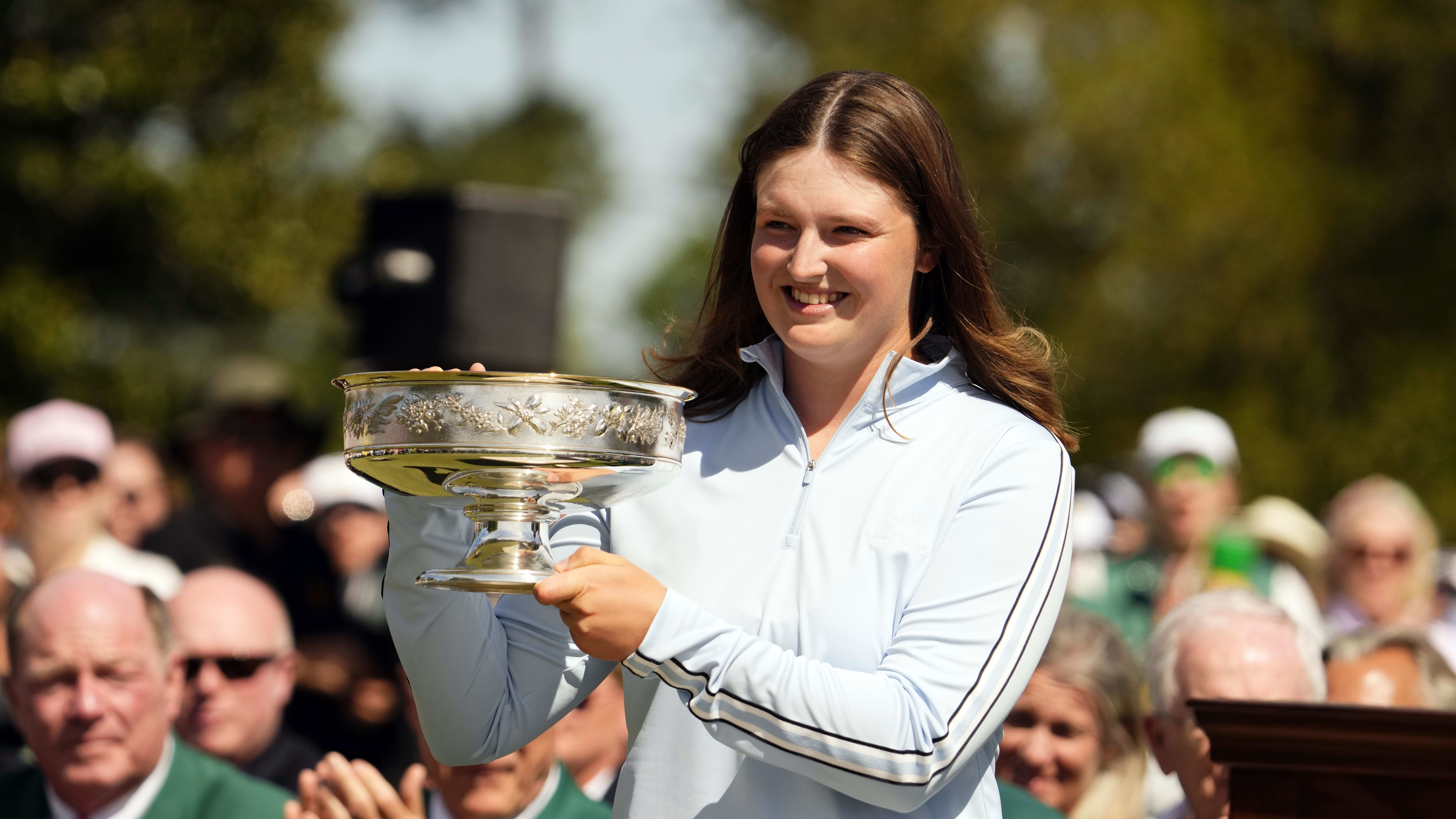 Golfer Lottie Woad holds the winner's trophy during a ceremony after the August National Women’s Amateur.