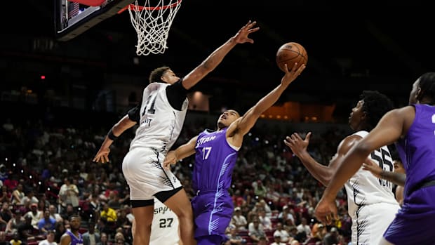 Utah's jazz striker John Tonje (17), heads for the basket against the San Antonio striker, Carter Bryant (11)