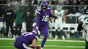 Oct 6, 2024; London, United Kingdom; Minnesota Vikings place kicker Will Reichard (16) kicks a 41-yard field goal out of the hold of punter Ryan Wright (17) in the fourth quarter against the New York Jets at Tottenham Hotspur Stadium. Mandatory Credit: Kirby Lee-Imagn Images
