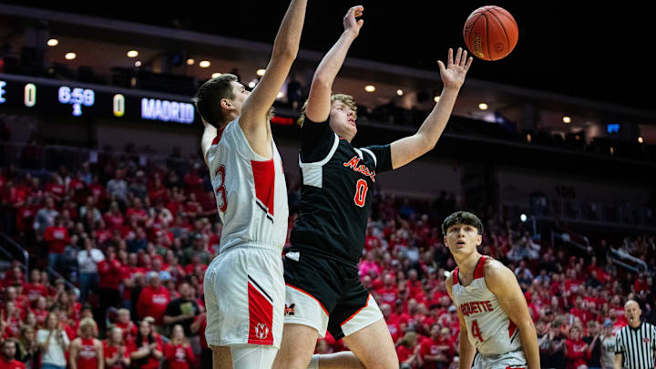 Madrid's Jevyn Severson (0) reaches for the ball against Marquette Catholic's Spencer Roeder (3) on Friday, March 14, 2025, at Wells Fargo Arena. Madrid's Jevyn Severson (0) reaches for the ball against Marquette Catholic's Spencer Roeder (3) on Friday, March 14, 2025, at Wells Fargo Arena.